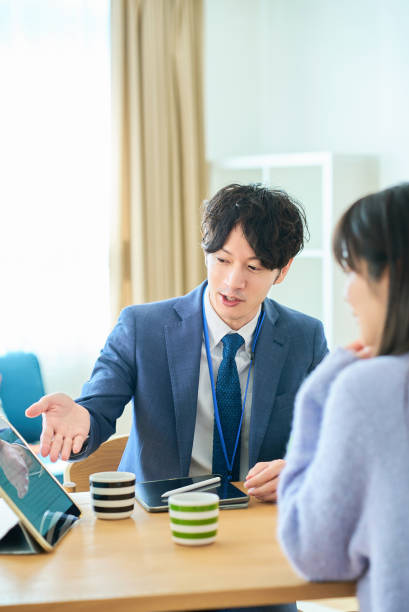 istock A man in a suit talking to a woman 2027809621