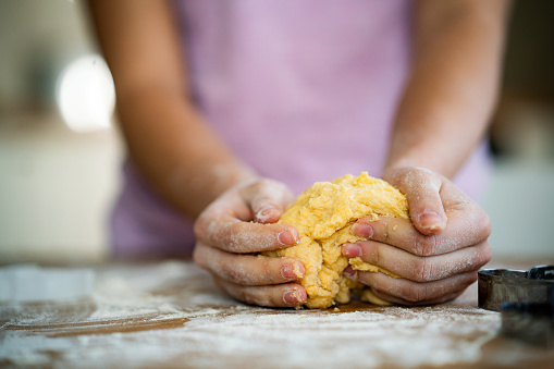 Close-up of unrecognizable girl making cookies at home