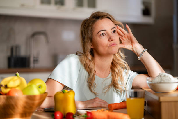 istock A stressed woman sits in the kitchen 2027814018