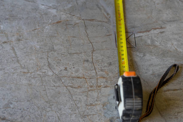 measuring construction meter on porcelain tiles