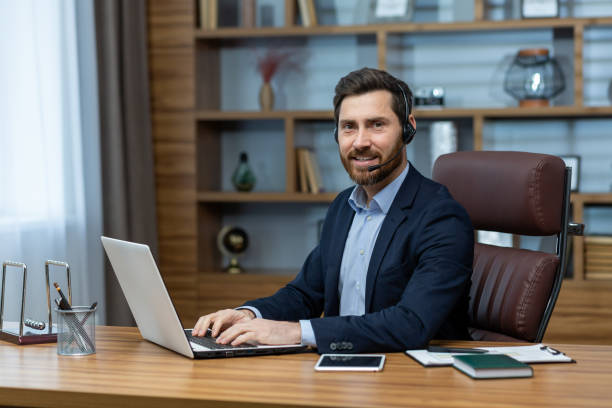 istock Confident businessman with a friendly smile working at a neat office desk 2027822180