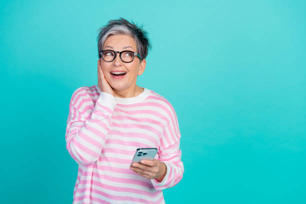 istock Photo of funky excited woman dressed pink pullover chatting modern gadget looking empty space isolated teal color background 2027827622