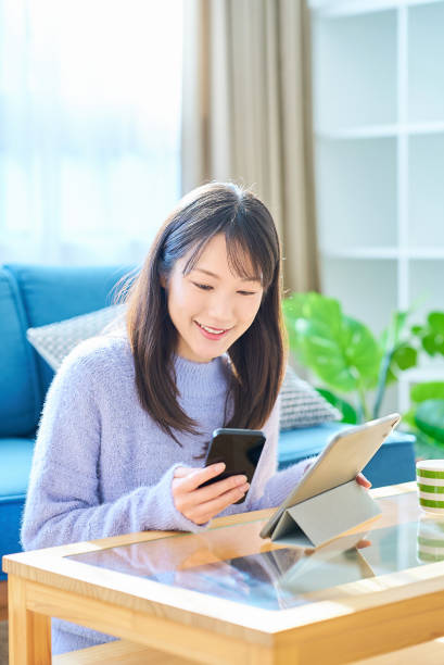 istock A woman comparing the screens of her smartphone and PC 2027829202