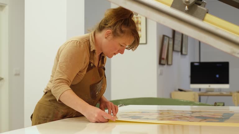 A woman setting up the printing table