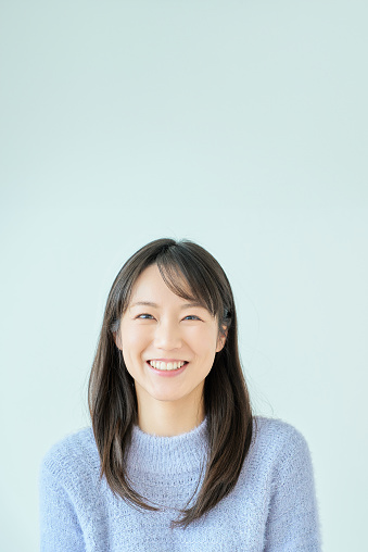 smiling young woman and white background in the room