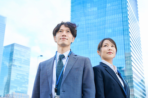 Man and woman in suits standing side by side