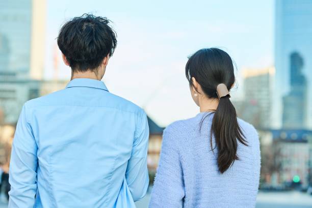 istock Smiling man and woman with smartphone in hand 2027879849