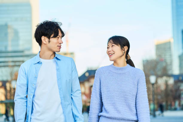 istock Young man and woman walking side by side 2027886117