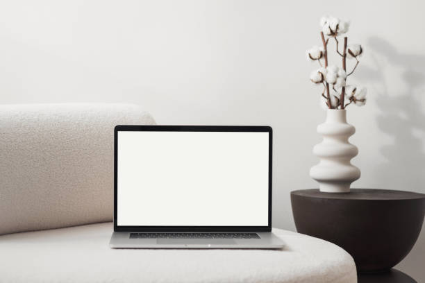 istock Working at home. Laptop with blank empty screen mockup on sofa 2027922604