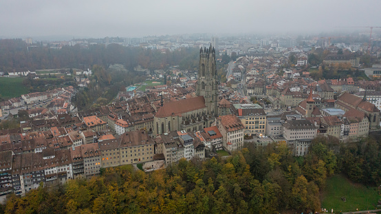 Aerial view drone footage of Fribourg famous old town in day time Switzerland,Aerial view of the Gothic style cathedral and the medieval old town in Fribourg in Swizterland