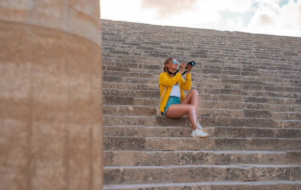 istock A woman tourist with a camera in the Acropolis on an excursion. 2027938677