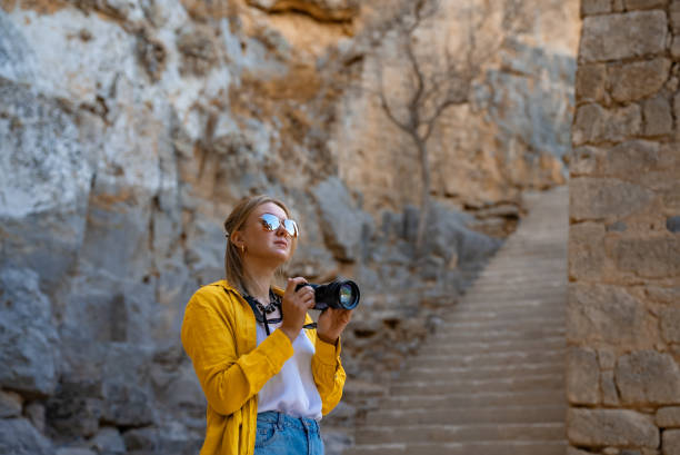 istock Woman tourist with a camera on an excursion. 2027939274