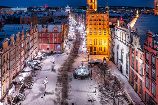 Gdansk, Poland - November 26, 2023: Winter snowfall on the historic center of Gdansk at the Neptune Fountain, Poland.