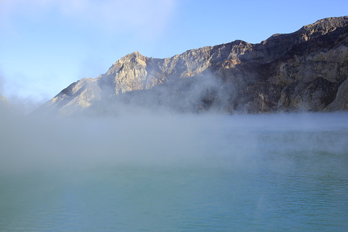 The haze covers surface of Ijen crater lake which is blue and has a high level of acidity due to the sulfur content.