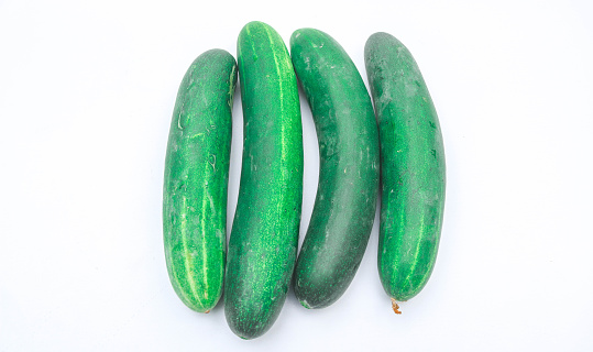 Collection of large fresh green cucumbers isolated on white background. Long cucumber from Asian agriculture