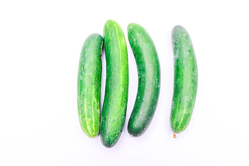 Collection of large fresh green cucumbers isolated on white background. Long cucumber from Asian agriculture