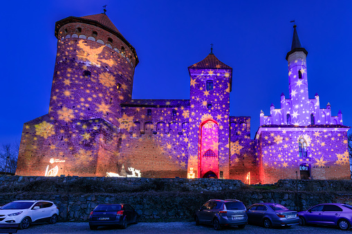Reszel, Poland - January 30, 2024: Christmas illuminations at the Teutonic castle in Reszel in Warmia at dusk, Poland.