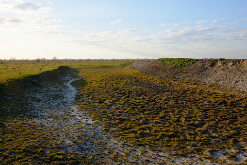 The exposed bottom of a dry pond. Landscape.
