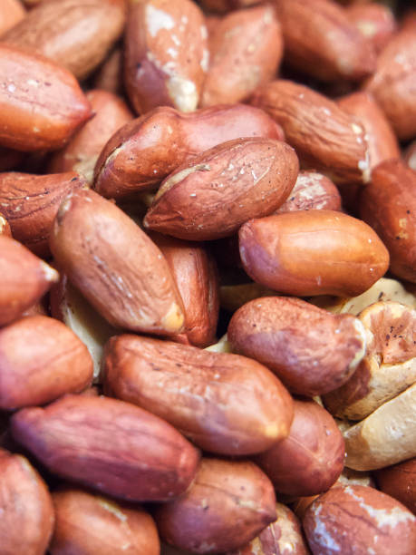 istock Roasted unpeeled peanuts macro, peanuts as a background. A lot of peeled peanuts. Full frame with peanuts. Selective focus. 2027992374