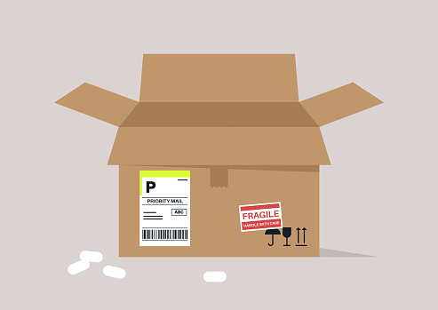 An open, empty cardboard box marked with priority and fragile labels