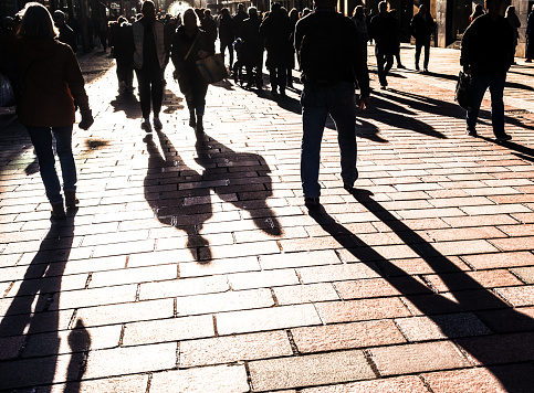 People on walking in bright sunshine on a Buchanan Street in central Glasgow, Scotland.