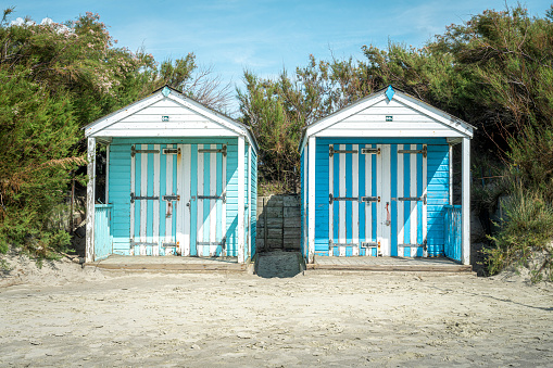 Two beach houses on a sandy beach in England