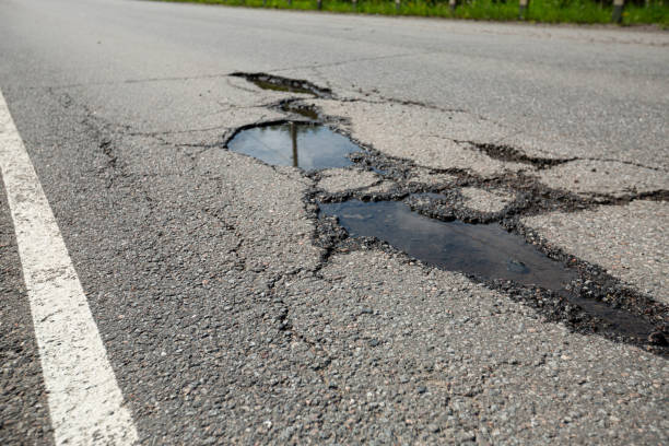 istock Potholes on bad asphalt road. Closeup 2028026733