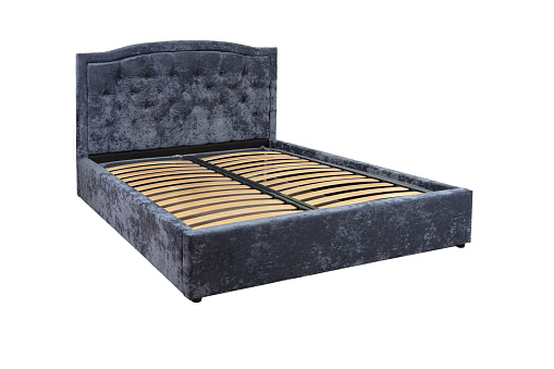 Gray double bed with wooden base without mattress.