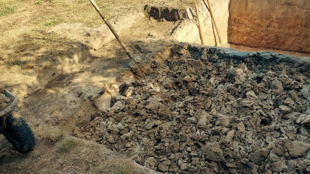 istock Pit in the ground. Digging a pit. The shovels in the pit. Earthworks, digging trench. 2028076363