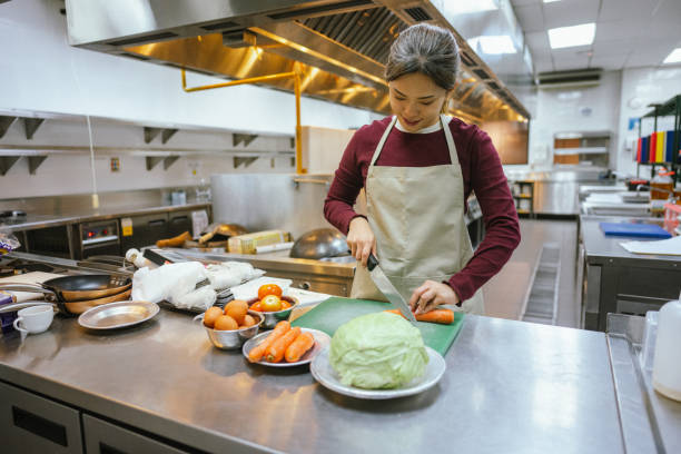 istock Culinary Creativity: Asian Students Mastering Ingredients in Cookery Class Kitchen 2028106299