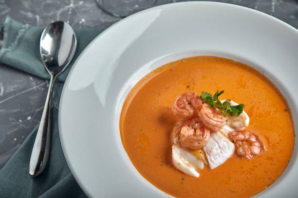 istock Fresh seafood soup in a white plate on dark background, top view 2028106327