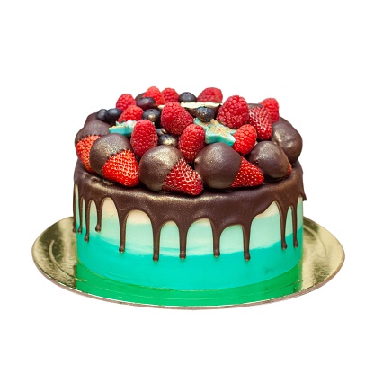 Green Birthday Cake with chocolate ganache and fresh berries isolated on white background, close up, png with copy space aside