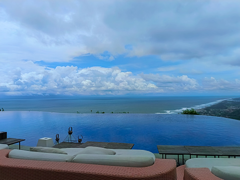 swimming pool views of the sea and beautiful cloudy blue skies