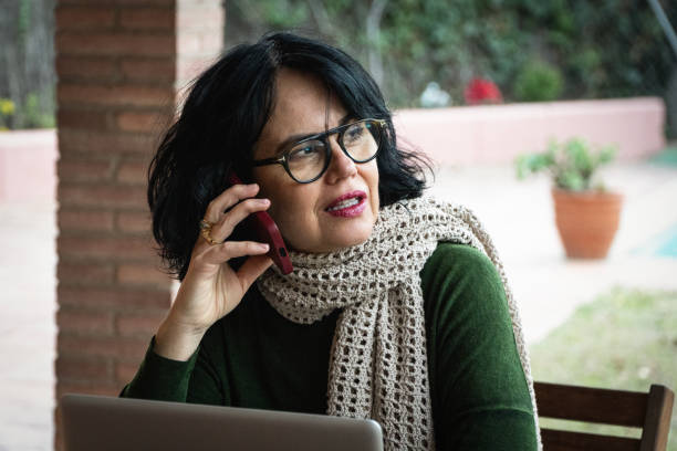 istock Mature woman working from home, taking a phone call 2028155293
