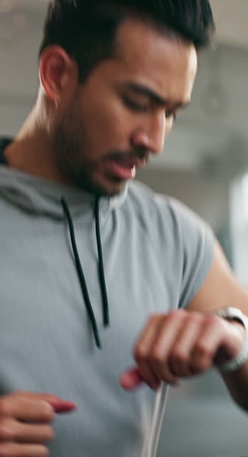 Fitness, treadmill and man running in the gym for race, speed or marathon training workout. Sports, smart watch and male athlete runner checking the time for a cardio exercise on an electric machine.