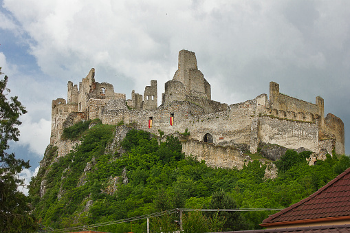 Beckov, Slovakia - June 9: The ancient 12th century Beckov Castle in Slovakia. Landscape with a medieval castle on top of a mountain June 9, 2023 in Beckov, Slovakia