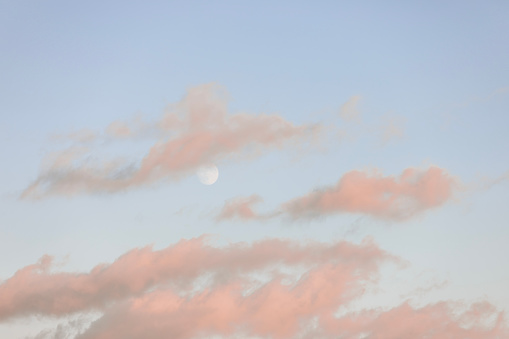 moon and clouds dark night background with a pink SLEEP word sinking into fluffy clouds with copy space for message