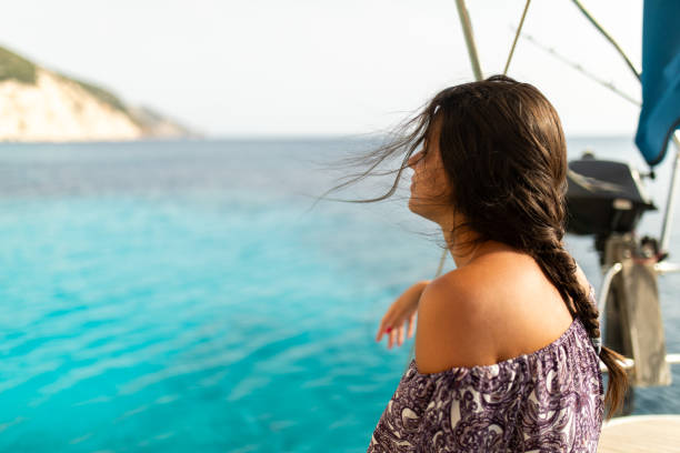 young woman relaxing on a sailboat - sailing light wind nautical vessel imagens e fotografias de stock