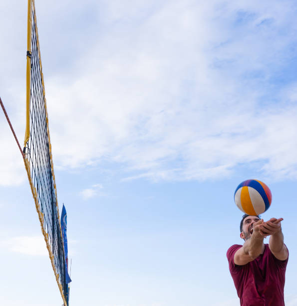 Beach volleyball player hitting the ball