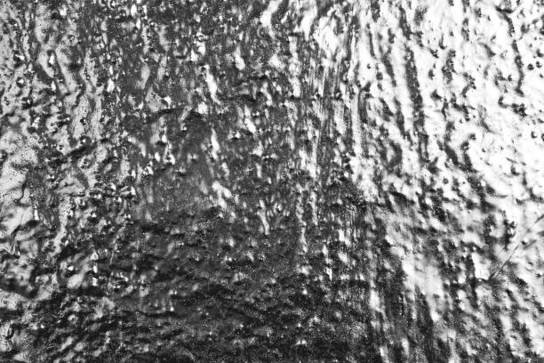 Silver paint on the wall background, authentic texture, grunge. Glossy, metallic silver spray paint.