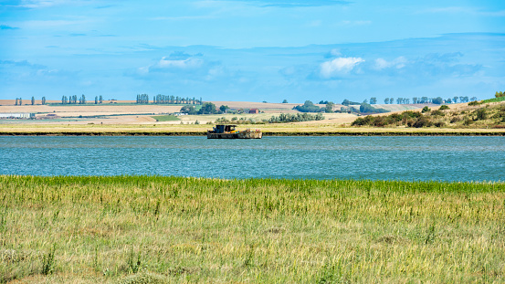 Wrecked Boat in the Swale Estuary in Oare near Faversham - Kent with the Isle of Sheppey in the distance