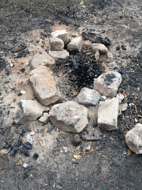 High angle view extinguished campfire among the paving stones in forest
