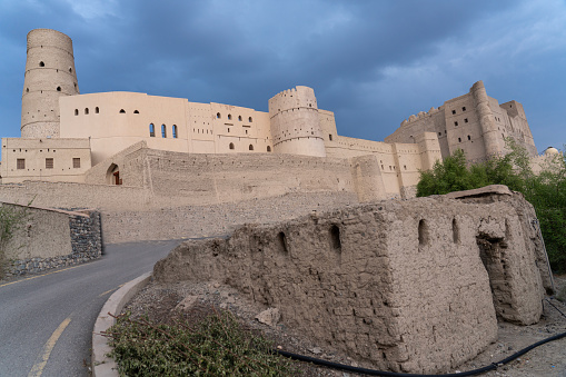 Historic Bahla Fort located at Djebel Akhdar highlands in the Sultanate of Oman against blue sky.