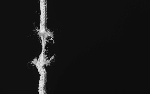 Frayed rope on black background.