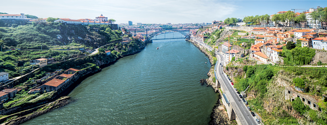 Panoramic view of the Douro river, the Luis I bridge and the city of Porto from Infante bridge, Portugal.