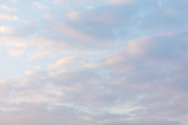 Cumulus white clouds floats in a clear blue sky for background