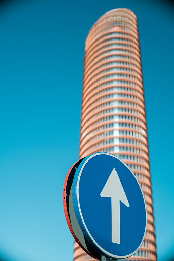 Traffic sign in front of Torre Sevilla skyscraper, Seville, Spain