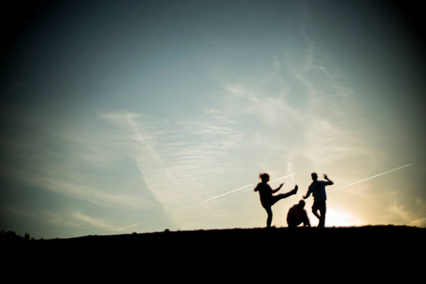 Young people having fun on the top of a hill