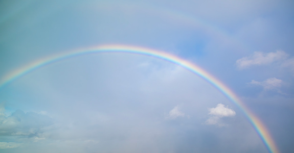 beautiful classic rainbow across in the blue sky after the rain