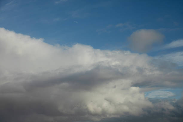 Nature background abstract photo of the beauty of the sky adorned with white, billowing cumulus clouds, creating an abstract texture against the vast expanse of bright blue. This panoramic view offers a captivating angle, showcasing the ethereal dance of clouds amidst the boundless sky. Immerse yourself in the tranquility of nature's canvas, where the interplay of light and shadow creates an ever-changing spectacle of wonder